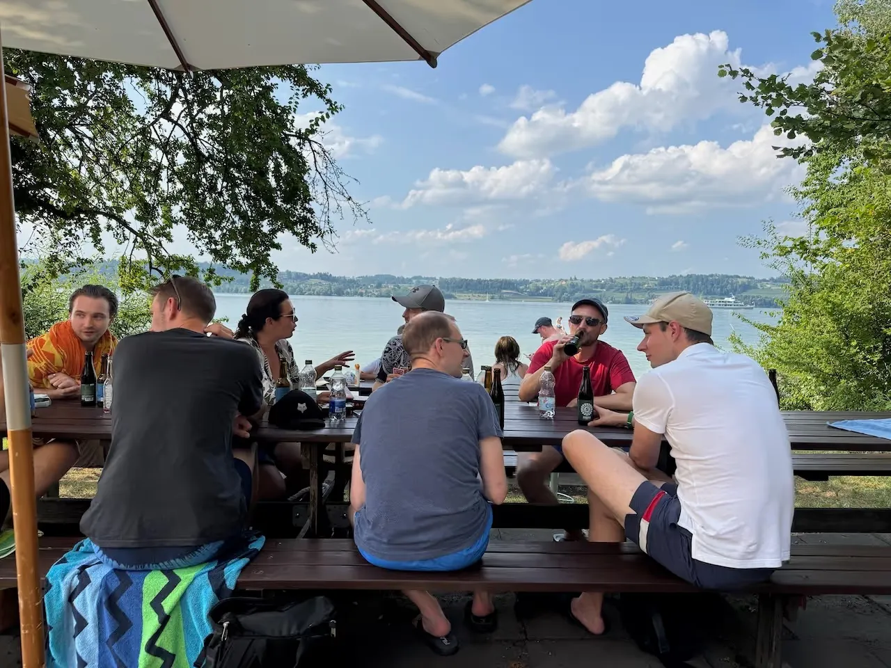 The Paymira team at a table by the lake